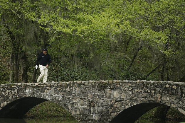 Phil Mickelson walks across the Byron Nelson Bridge during a practice round for the Masters golf tournament Tuesday, April 8, 2014, in Augusta, Ga. (AP Photo/Chris Carlson)