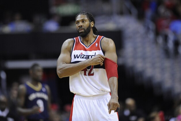 Washington Wizards power forward Nene (42), of Brazil, adjusts his arm sleeve during the second half of an NBA basketball game, Saturday, Feb. 22, 2014, in Washington. The Wizards won 94-93. (AP Photo/Nick Wass)