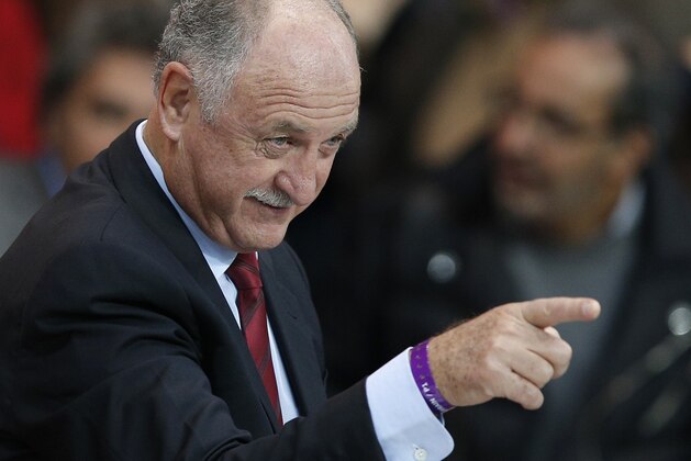 Luiz Felipe Scolari, the coach of the Brazilian national soccer team, gestures as he arrives for the Champions League quarterfinal first leg soccer match between PSG and Chelsea, at the Parc des Princes stadium, in Paris, Wednesday, April 2, 2014. (AP Photo/Christophe Ena)
