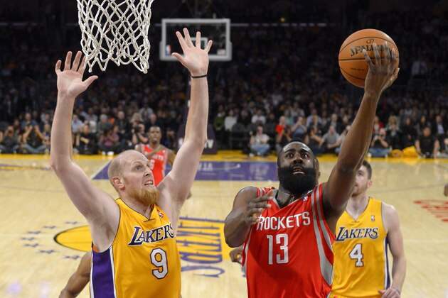 Houston Rockets guard James Harden, right, puts up a shot as Los Angeles Lakers center Chris Kaman defends during the first half of an NBA basketball game, Wednesday, Feb. 19, 2014, in Los Angeles. (AP Photo/Mark J. Terrill)