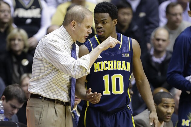 Michigan head coach John Beilein, left, talks with guard Derrick Walton Jr. in the first half of an NCAA college basketball game in West Lafayette, Ind., Wednesday, Feb. 26, 2014. (AP Photo/Michael Conroy) Michigan head coach John Beilein, left, talks with guard Derrick Walton Jr. in the first half of an NCAA college basketball game in West Lafayette, Ind., Wednesday, Feb. 26, 2014. (AP Photo/Michael Conroy)