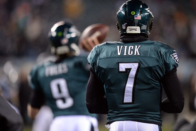 Jan 4, 2014; Philadelphia, PA, USA; Philadelphia Eagles quarterback Michael Vick (7) looks on as quarterback Nick Foles (9) warms up before the 2013 NFC wild card playoff football game against the New Orleans Saints at Lincoln Financial Field. Mandatory Credit: Joe Camporeale-USA TODAY Sports