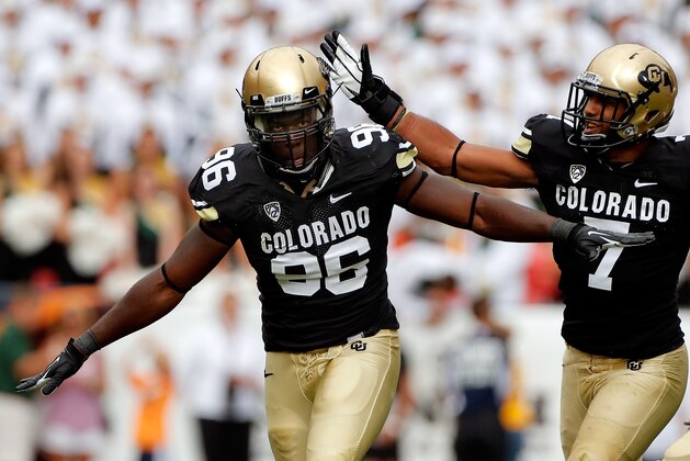 DENVER, CO - SEPTEMBER 01:  Defensive lineman Chidera Uzo-Diribe #96 of the Colorado Buffaloes celebrates his sack of quarterback Garrett Grayson #18 of the Colorado State Rams with free safety Ray Polk #7 of the Colorado Buffaloes in the Rocky Mountain Showdown at Sports Authority Field at Mile High on September 1, 2012 in Denver, Colorado.  (Photo by Doug Pensinger/Getty Images)