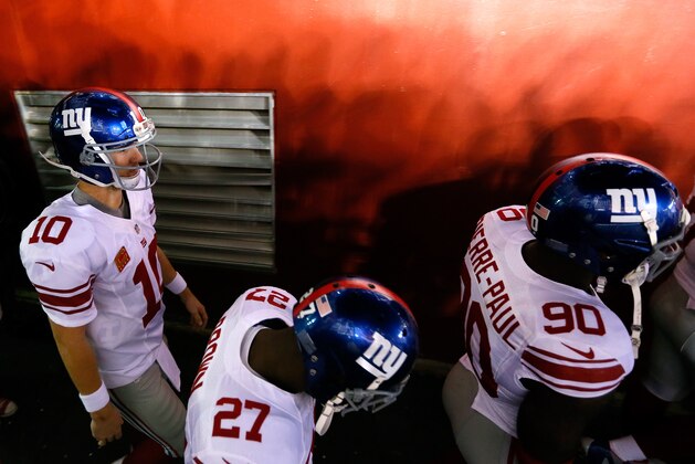 LANDOVER, MD - DECEMBER 03:  (L-R) Eli Manning #10, Stevie Brown #27 and Jason Pierre-Paul #90 of the New York Giants walk onto the field to take on the Washington Redskins at FedExField on December 3, 2012 in Landover, Maryland.  (Photo by Rob Carr/Getty Images)