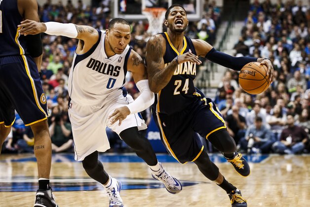 Indiana Pacers small forward Paul George (24) gets fouled by Dallas Mavericks' Shawn Marion (0) during the second half of an NBA game, Sunday, Mar. 9, 2014, in Dallas, Texas. The Dallas Mavericks won 105-94. (AP Photo/Jim Cowsert)