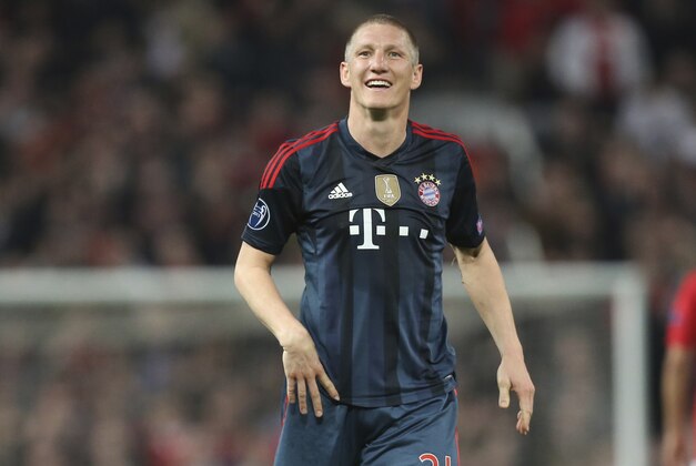 Bayern's Bastian Schweinsteiger smiles after he was sent off the field during the Champions League quarterfinal first leg soccer match between Manchester United and Bayern Munich at Old Trafford Stadium, Manchester, England, Tuesday, April 1, 2014.(AP Photo/Jon Super)