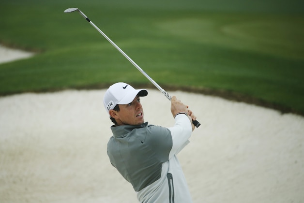 Rory McIlroy, of Northern Ireland, watches his chip shot while on the practice range in preparation for the Masters golf tournament Monday, April 7, 2014, in Augusta, Ga. (AP Photo/Matt Slocum)