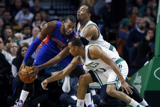 Detroit Pistons power forward Greg Monroe (10) looks to make a move against Boston Celtics forward Jared Sullinger and point guard Avery Bradley (0) in the second half of an NBA basketball game in Boston, Wednesday, Dec. 18, 2013. The Pistons won 107-106. (AP Photo/Elise Amendola)