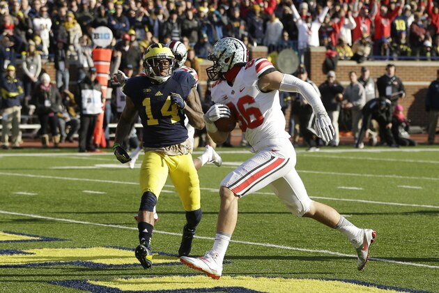 Ohio State tight end Jeff Heuerman (86), defended by Michigan safety Josh Furman (14), scores during the second half of an NCAA college football game in Ann Arbor, Mich., Saturday, Nov. 30, 2013. (AP Photo/Carlos Osorio)