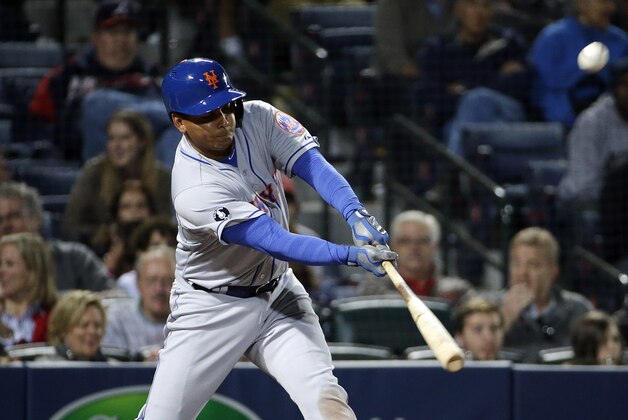 New York Mets' Ruben Tejada singles to score teammate Lucas Duda in the eighth inning of baseball game against the Atlanta Braves, Tuesday, April 8, 2014, in Atlanta. (AP Photo/David Goldman)