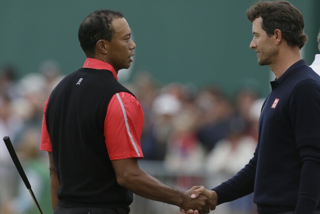 Tiger Woods of the United States, left, and Adam Scott of Australia shake hands after their final round of the British Open Golf Championship at Muirfield, Scotland, Sunday July 21, 2013. (AP Photo/Jon Super)
