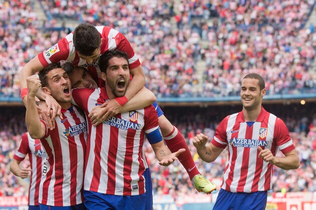 MADRID, SPAIN - APRIL 05:  Raul Garcia (2ndR) of Atletico de Madrid celebrates scoring their opening goal with teammates Koke (L), Diego Godin (2ndL)David Villa (3dL) and Mario Suarez (R) during the La Liga match between Club Atletico de Madrid and Villarreal CF at Vicente Calderon Stadium on April 5, 2014 in Madrid, Spain.  (Photo by Gonzalo Arroyo Moreno/Getty Images)