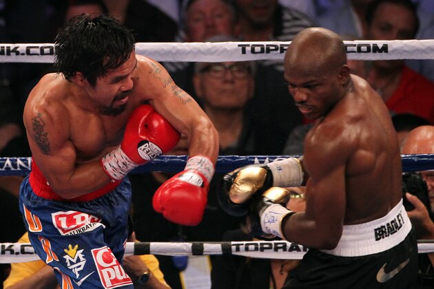 LAS VEGAS, NV - JUNE 09:  (L-R) Manny Pacquiao lands a left to the head of Timothy Bradley during their WBO welterweight title fight at MGM Grand Garden Arena on June 9, 2012 in Las Vegas, Nevada.  (Photo by Jeff Bottari/Getty Images)