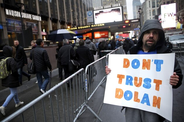 Brian Platero holds up a sign during a protest against New York Knicks owner James Dolan before an NBA basketball game between the Knicks and the Indiana Pacers at Madison Square Garden, Wednesday, March 19, 2014, in New York. (AP Photo/Seth Wenig) Brian Platero holds up a sign during a protest against New York Knicks owner James Dolan before an NBA basketball game between the Knicks and the Indiana Pacers at Madison Square Garden, Wednesday, March 19, 2014, in New York. (AP Photo/Seth Wenig)