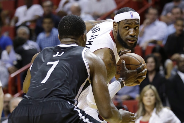Miami Heat forward LeBron James, right, looks for an open teammate past Brooklyn Nets guard Joe Johnson (7) during the first half of an NBA basketball game, Wednesday, March 12, 2014, in Miami. (AP Photo/Wilfredo Lee)