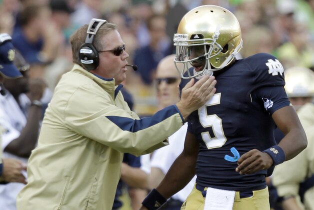 FILE - In this Sept. 8, 2012, file photo, Notre Dame coach Brian Kelly, left, gives a play to quarterback Everett Golson during the first half of an NCAA college football game against Purdue in South Bend, Ind. Golson's high school coach says he believes the quarterback will learn from being suspended by Notre Dame for the fall semester. (AP Photo/Michael Conroy, File) FILE - In this Sept. 8, 2012, file photo, Notre Dame coach Brian Kelly, left, gives a play to quarterback Everett Golson during the first half of an NCAA college football game against Purdue in South Bend, Ind. Golson's high school coach says he believes the quarterback will learn from being suspended by Notre Dame for the fall semester. (AP Photo/Michael Conroy, File)