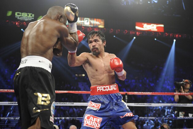 Manny Pacquiao, right, and Timothy Bradley during their WBO world welterweight title fight Saturday, June 9, 2012, in Las Vegas. (AP Photo/Chris Carlson)