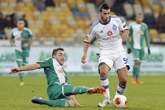 Rapid's Thanos Petsos, left, and Dynamo Kyiv's Younes Belhanda  challenge for the ball, during the Europa League  group G soccer match between SK Rapid Wien and FC Dynamo Kyiv, in Kiev Ukraine, Thursday, Dec. 12, 2013. (AP Photo(AP Photo/Efrem Lukatsky)