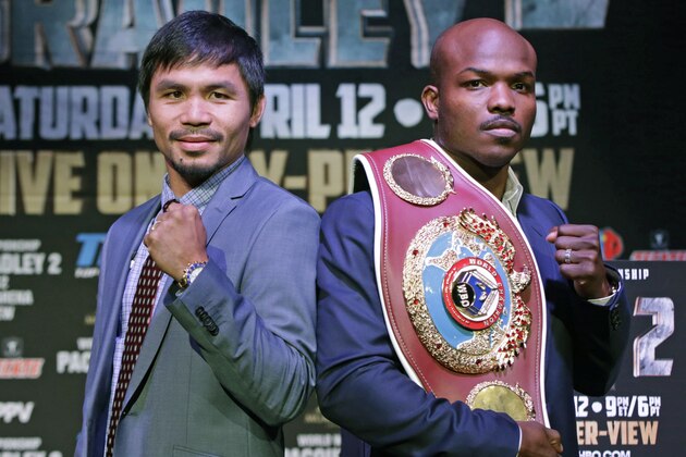 Boxer Manny Pacquiao, of the Phillipines, left, poses for a photo with Timothy Bradley of Indio, Ca., the current WBO World Welterweight champion, during a press conference,Thursday, Feb. 6, 2014, in New York.  The pair will face off in a rematch April 12, 2014, in Las Vegas. Bradley won their first encounter. (AP Photo/Kathy Willens)