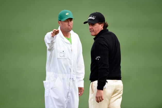 AUGUSTA, GA - APRIL 08:  Phil Mickelson of the United States talks with his caddie Jim Mackayduring a practice round prior to the start of the 2014 Masters Tournament at Augusta National Golf Club on April 8, 2014 in Augusta, Georgia.  (Photo by Harry How/Getty Images)