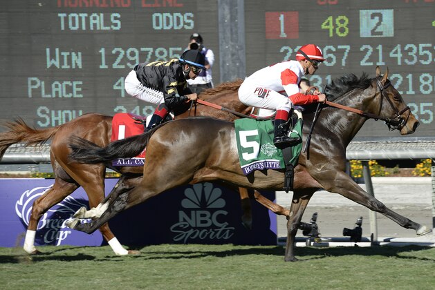 Nov 1, 2013; Arcadia, CA, USA; Javier Castellano aboard Bobby's Kitten leads Luis Saez aboard All Cash during race seven of the 2013 Breeders' Cup Championships at Santa Anita Park. Mandatory Credit: Richard Mackson-USA TODAY Sports