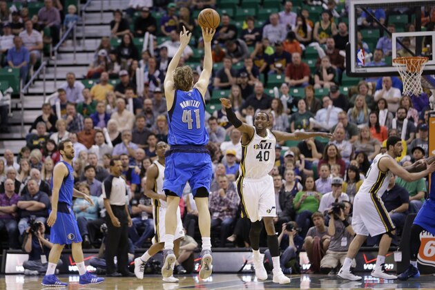 Dallas Mavericks' Dirk Nowitzki (41) shoots a 3-pointer as Utah Jazz's Jeremy Evans (40) defends in the fourth quarter of an NBA basketball game Tuesday, April 8, 2014, in Salt Lake City. The Mavericks won 95-83. (AP Photo/Rick Bowmer)