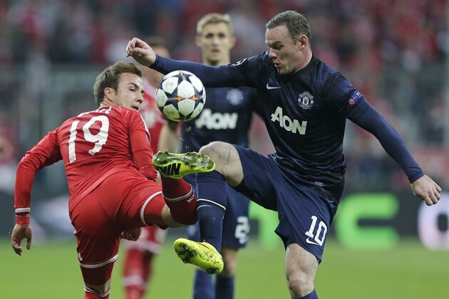 Bayern's Mario Goetze, left, is challenged by Manchester United's Wayne Rooney during the Champions League quarterfinal second leg soccer match between Bayern Munich and Manchester United in the Allianz Arena in Munich, Germany, Wednesday, April 9, 2014. (AP Photo/Matthias Schrader)