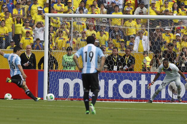 Argentina's Sergio Aguero, left, prepares to score a penalty as Ecuador's goalkeeper Alexander Dominguez looks on during a 2014 World Cup qualifying soccer match in Quito, Ecuador, Tuesday, June 11, 2013.  (AP Photo/Dolores Ochoa)