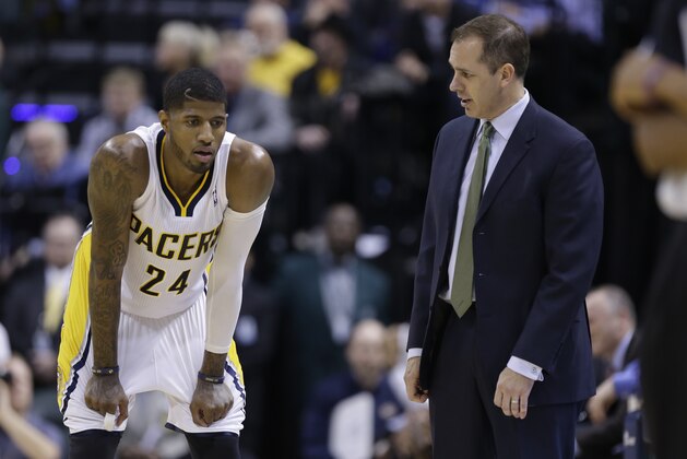 Indiana Pacers head coach Frank Vogel, right talks with forward Paul George  in the second half of an NBA basketball game against the Sacramento Kings in Indianapolis, Tuesday, Jan. 14, 2014. The Pacers defeated the Kings 116-92. (AP Photo/Michael Conroy)