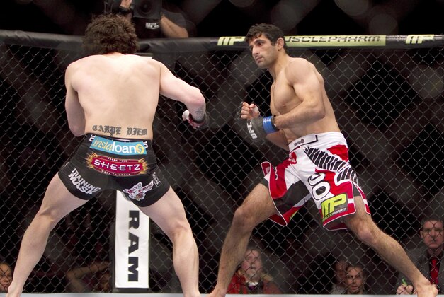 Jan 15, 2014; Duluth, GA, USA; Charlie Brenneman (red gloves) fights with Beneil Dariush (blue gloves) during UFC Fight Night at Gwinnett Center. Dariush won. Mandatory Credit: Joshua S. Kelly-USA TODAY Sports