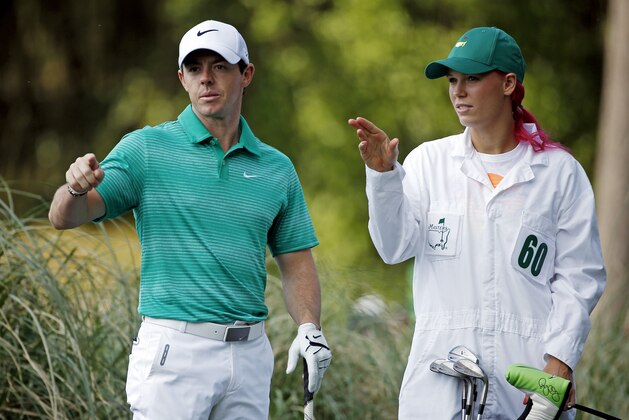 Tennis player Caroline Wozniacki talks with her fiancee Rory McIlroy, of Northern Ireland, during the par three competition at the Masters golf tournament Wednesday, April 9, 2014, in Augusta, Ga. (AP Photo/Matt Slocum)