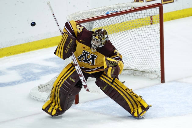 Minnesota goalie Adam Wilcox deflects a shot during the third period of an NCAA West college regional hockey game against St. Cloud State in St. Paul, Minn., Sunday, March 30, 2014. Minnesota won 4-0. (AP Photo/Ann Heisenfelt)