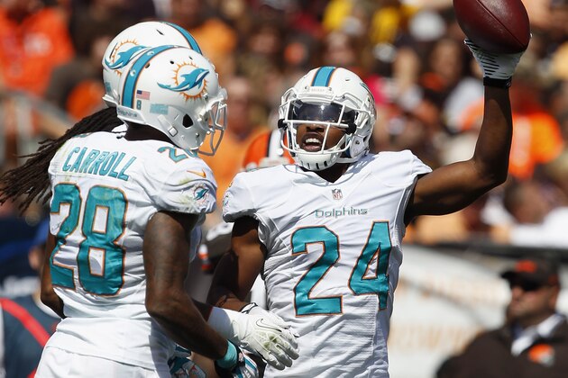 CLEVELAND, OH - SEPTEMBER 08:  Cornerback Dimitri Patterson #24 of the Miami Dolphins celebrates with cornerback Nolan Carroll #28 after an interception against the Cleveland Browns at Cleveland Browns Stadium on September 8, 2013 in Cleveland, Ohio.  (Photo by Matt Sullivan/Getty Images)