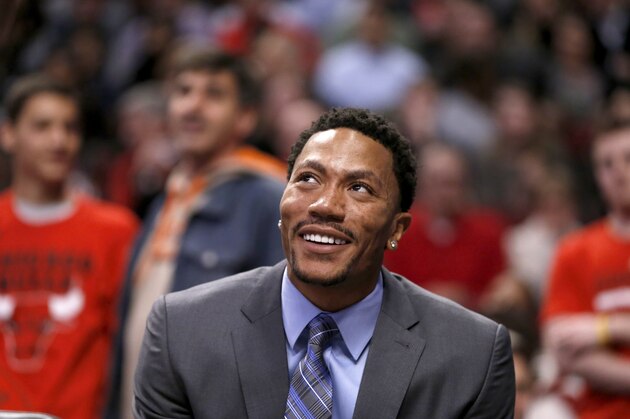 Chicago Bulls guard Derrick Rose listens to Carlos Boozer  on the bench during the second half of an NBA basketball game against the Portland Trail Blazers Friday, March 28, 2014, in Chicago. The Trail Blazers won 91-74. (AP Photo/Charles Rex Arbogast)