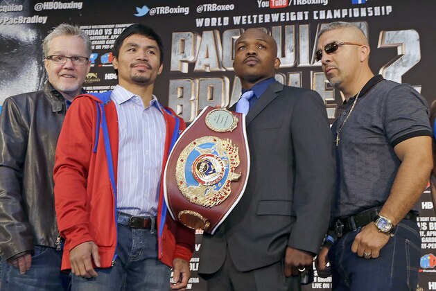 From left, trainer Freddie Roach and Manny Pacquiao, of the Philippines, and Tim Bradley and his trainer Joel Diaz pose at a news conference to promote their upcoming WBO welterweight championship boxing rematch, Pacquiao Bradley 2, in Beverly Hills, Calif., Tuesday, Feb. 4, 2014. Pacquiao and Bradley's first match on June 9, 2012 was a split decision in favor of Bradley, which ended Pacquiao's welterweight title reign as well as his seven-year, 15-bout winning streak.  Pacquiao vs. Bradley 2 will take place Saturday, April 12, 2014, in Las Vegas. (AP Photo/Reed Saxon)
