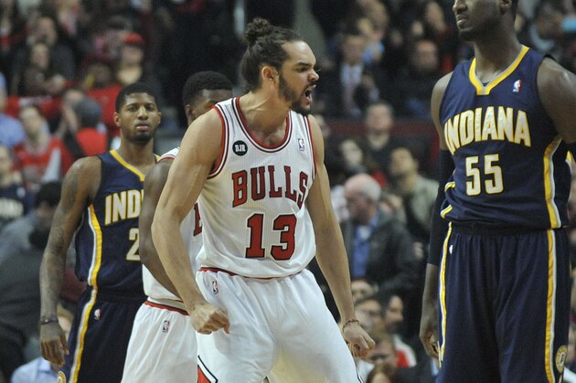Mar 24, 2014; Chicago, IL, USA; Chicago Bulls center Joakim Noah (13) reacts after play against Indiana Pacers center Roy Hibbert (55) during the first quarter at the United Center. Mandatory Credit: David Banks-USA TODAY Sports