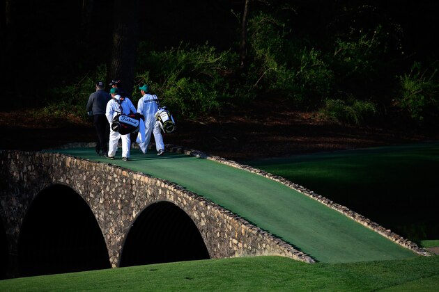 AUGUSTA, GA - APRIL 09:  Mark O'Meara of the United States and Hideki Matsuyama of Japan walk with their caddies over the Hogan Bridge during a practice round prior to the start of the 2014 Masters Tournament at Augusta National Golf Club on April 9, 2014 in Augusta, Georgia.  (Photo by Rob Carr/Getty Images)