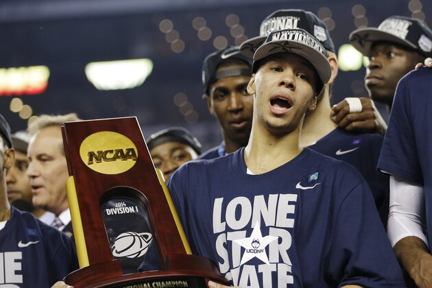 Connecticut guard Shabazz Napier holds the championship trophy after defeating Kentucky 60-54, at the NCAA Final Four tournament college basketball championship game Monday, April 7, 2014, in Arlington, Texas. (AP Photo/David J. Phillip) Connecticut guard Shabazz Napier holds the championship trophy after defeating Kentucky 60-54, at the NCAA Final Four tournament college basketball championship game Monday, April 7, 2014, in Arlington, Texas. (AP Photo/David J. Phillip)