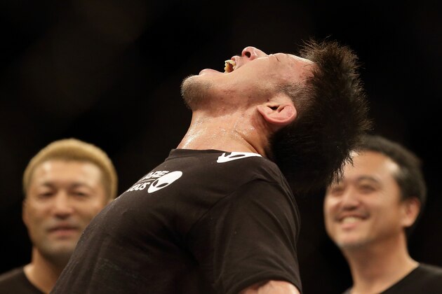 SINGAPORE - JANUARY 04:  Tatsuya Kawajiri reacts after defeating Sean Soriano during their UFC Fight Night Singapore featherweight bout at Marina Bay Sands on January 4, 2014 in Singapore.  (Photo by Suhaimi Abdullah/Getty Images)