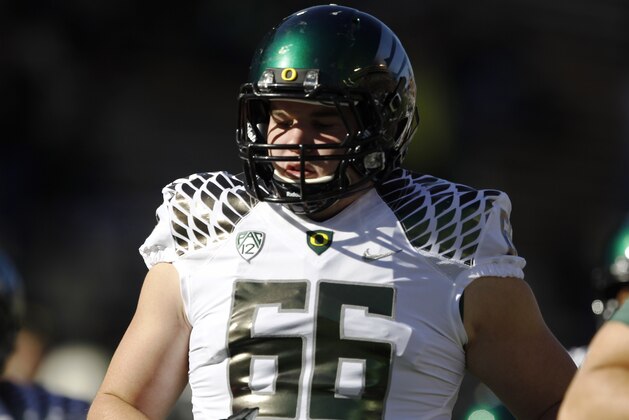 Oregon defensive end Taylor Hart warms up before facing Colorado in the first quarter of an NCAA college football game in Boulder, Colo., on Saturday, Oct. 5, 2013. (AP Photo/David Zalubowski)