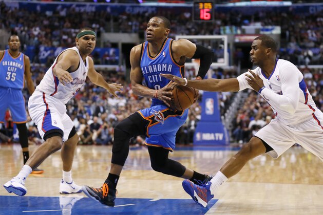 Oklahoma City Thunder guard Russell Westbrook, center, drives between Los Angeles Clippers forward Jared Dudley, left, and guard Chris Paul during the first half of an NBA basketball game in Los Angeles, Wednesday, April 9, 2014. (AP Photo/Danny Moloshok)