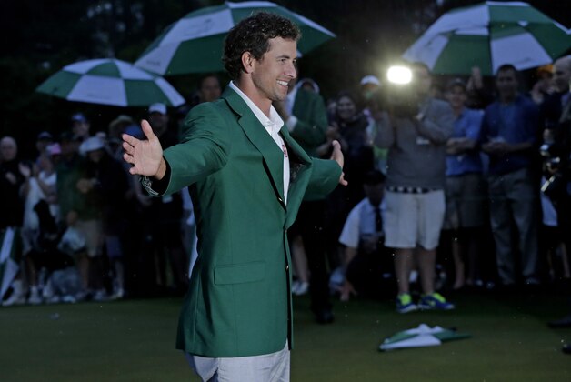 Adam Scott, of Australia, celebrates with his  green jacket after winning the Masters golf tournament Sunday, April 14, 2013, in Augusta, Ga.  (AP Photo/Charlie Riedel)