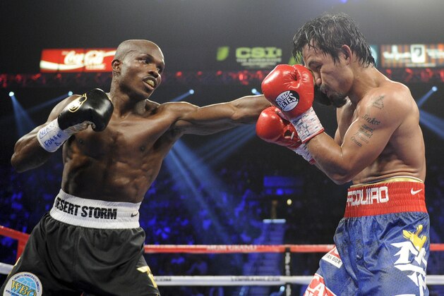 Timothy Bradley, from Palm Springs, Calif., left, lands a punch against Manny Pacquiao, from the Philippines, in their WBO world welterweight title fight Saturday, June 9, 2012, in Las Vegas. Bradley won the fight by split decision. (AP Photo/Chris Carlson)
