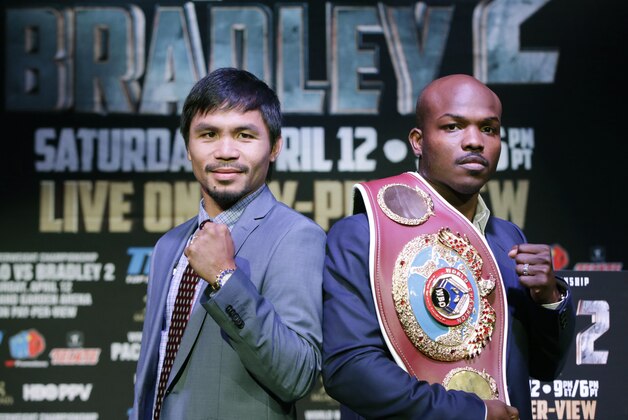 Boxer Manny Pacquiao, of the Phillipines, left, poses for a photo with current WBO World Welterweight champion Timothy Bradley of Indio, Calif., during a press conference Thursday, Feb. 6, 2014, in New York. The pair will face off in a title fight in Las Vegas, April 12, 2014. (AP Photo/Kathy Willens)