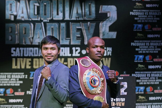 Boxer Manny Pacquiao, of the Phillipines, left, poses for a photo with Timothy Bradley of Indio, Ca., the current WBO World Welterweight champion, during a press conference,Thursday, Feb. 6, 2014, in New York.  The pair will face off in a rematch April 12, 2014, in Las Vegas. Bradley won their first encounter. (AP Photo/Kathy Willens)