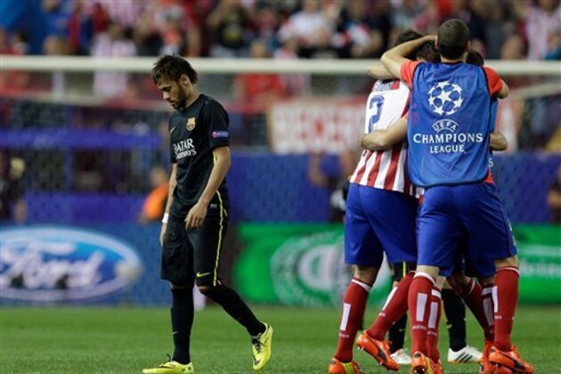 Barcelona's Neymar, left, leaves the pitch as Atletico players celebrate at the end of the Champions League quarterfinal second leg soccer match between Atletico Madrid and FC Barcelona in the Vicente Calderon stadium in Madrid, Spain, Wednesday, April 9, 2014. Atletico defeated Barcelona 1-0. (AP Photo/Paul White)
