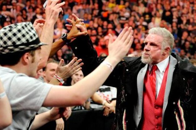 FILE - In this April 5, 2014 file photo provided by the WWE, James Hellwig, aka The Ultimate Warrior, is escorted by his daughters to the stage during the WWE Hall of Fame Induction at the Smoothie King Center in New Orleans. The WWE said Hellwig, one of pro wrestling's biggest stars in the late 1980s, died Tuesday, April 8, 2014. He was 54. (Jonathan Bachman/AP Images for WWE, File)