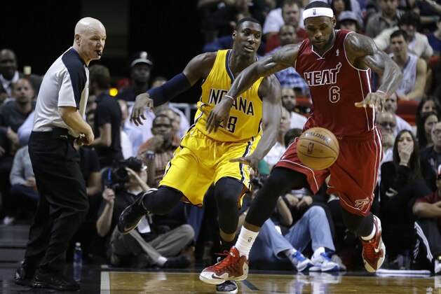 Miami Heat's LeBron James (6) steals the ball from Indiana Pacers' Ian Mahinmi (28) during the second half of an NBA basketball game, Wednesday, Dec. 18, 2013, in Miami. The Heat defeated the Pacers 97-94. (AP Photo/Lynne Sladky)