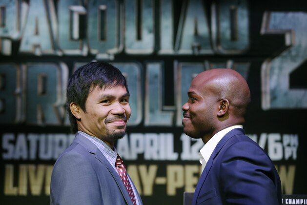 Boxer Manny Pacquiao, left, of the Phillipines, glances back during a photo opportunity with Timothy Bradley of Indio, Ca., the current WBO World Welterweight champion, during a press conference,Thursday, Feb. 6, 2014, in New York.  The pair will face off in a WBO World Welterweight title fight April 12, 2014, in Las Vegas. (AP Photo/Kathy Willens)