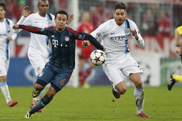 Bayern's Thiago Alcantara, left, and Manchester City's Javi Garcia challenge for the ball during the Champions League group D soccer match between FC Bayern Munich and Manchester City, in Munich, southern Germany, Tuesday, Dec. 10, 2013. (AP Photo/Matthias Schrader)